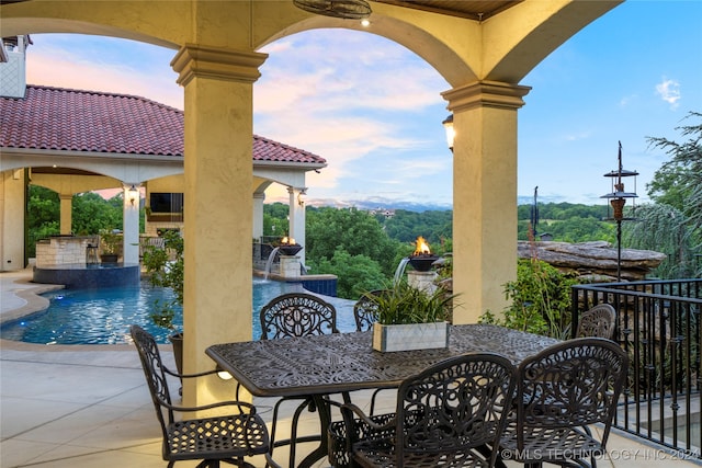 patio terrace at dusk with pool water feature