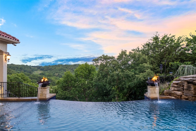 view of pool at dusk