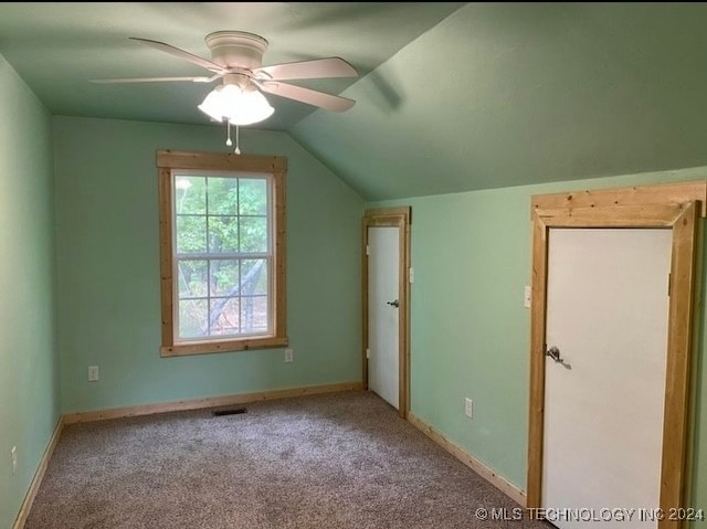 additional living space with light colored carpet, ceiling fan, and lofted ceiling