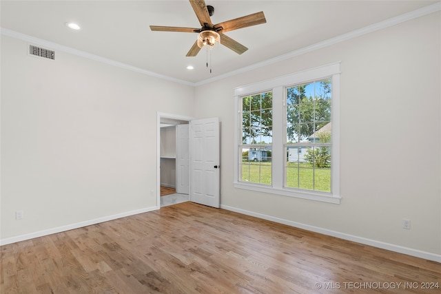 spare room featuring light hardwood / wood-style flooring, ceiling fan, and crown molding