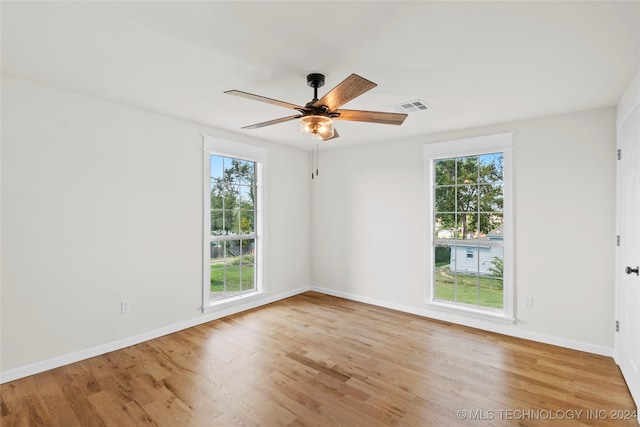 unfurnished room featuring plenty of natural light, light hardwood / wood-style floors, and ceiling fan