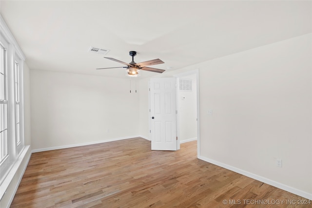 spare room featuring light hardwood / wood-style flooring and ceiling fan