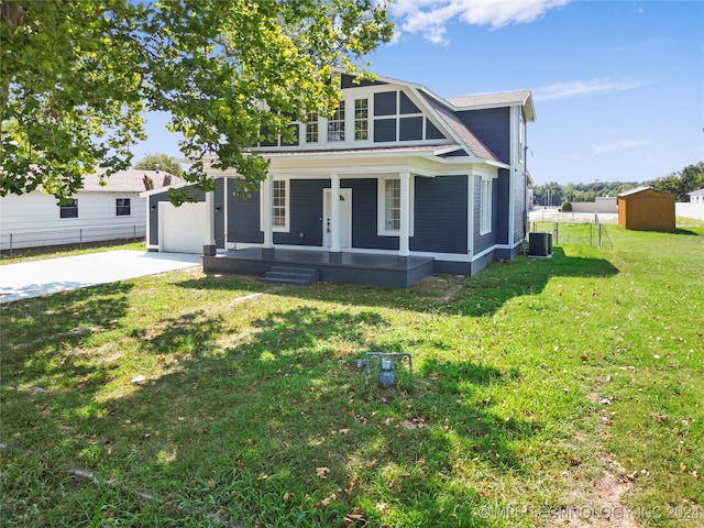 view of front facade with a storage unit, a porch, central air condition unit, and a front lawn