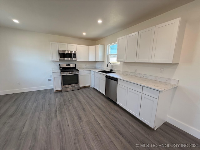 kitchen with white cabinetry, appliances with stainless steel finishes, dark wood-type flooring, and sink