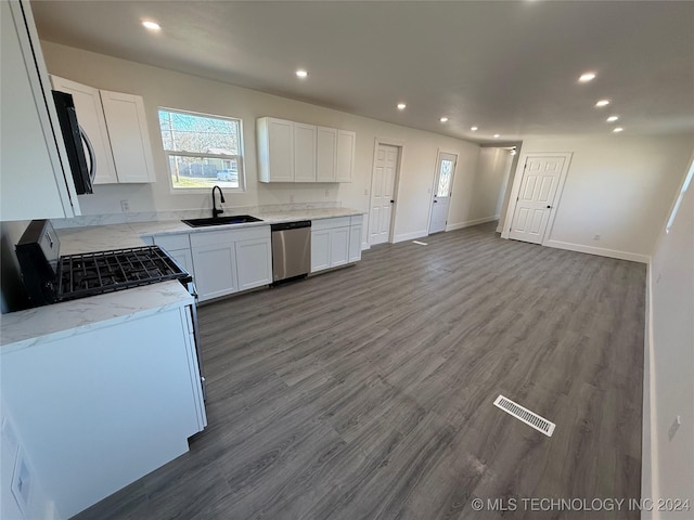 kitchen with dark wood-type flooring, sink, dishwasher, light stone countertops, and white cabinets