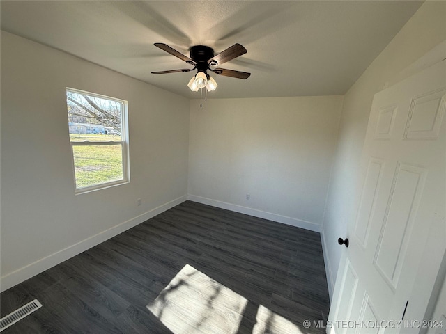 empty room with dark hardwood / wood-style floors and ceiling fan