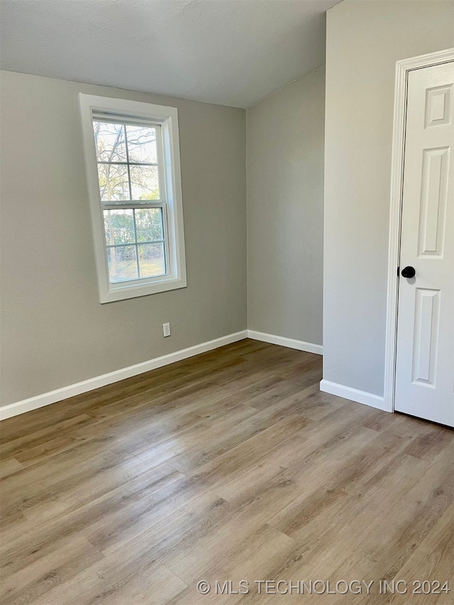 spare room featuring light wood-type flooring