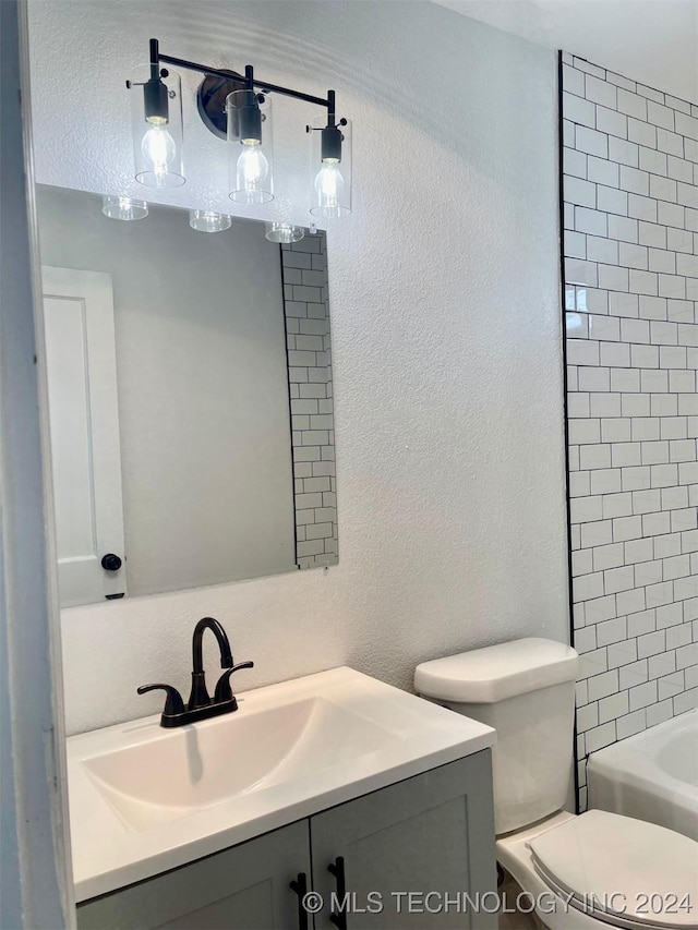 bathroom featuring vanity and toilet