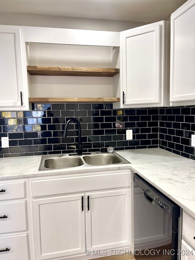 kitchen with white cabinetry, black dishwasher, and sink