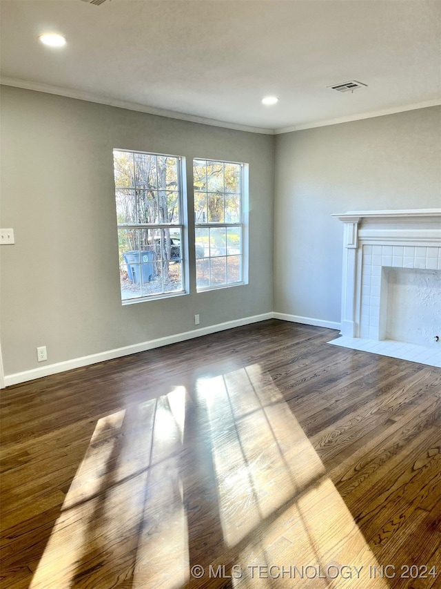 unfurnished living room with dark wood-type flooring and ornamental molding