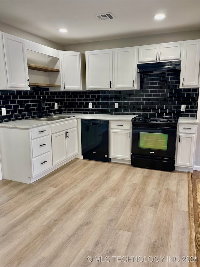 kitchen with white cabinetry, light wood-type flooring, and black appliances