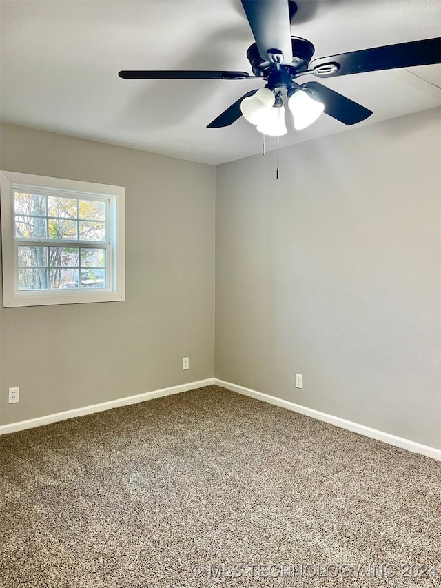 spare room featuring ceiling fan and carpet flooring