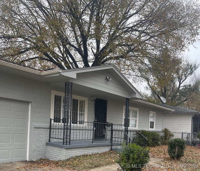 view of front of property with a porch and a garage