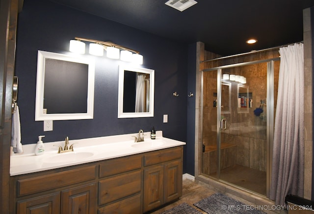 bathroom with vanity and a shower with door