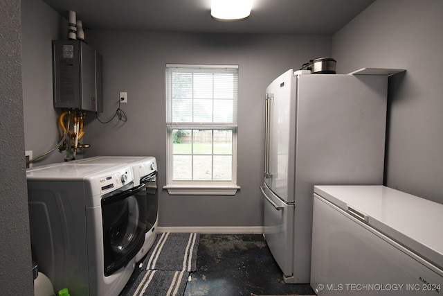 washroom with washing machine and dryer and water heater