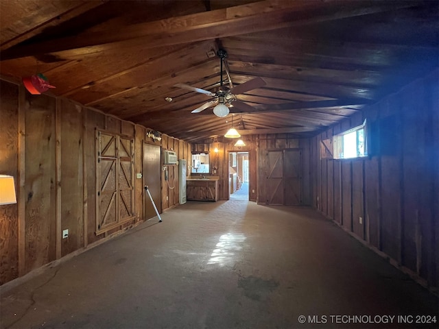 basement featuring wooden walls