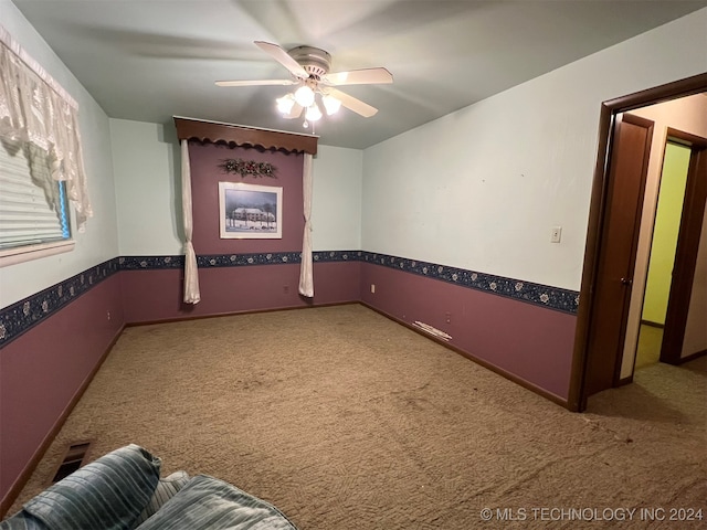 unfurnished room featuring carpet and ceiling fan