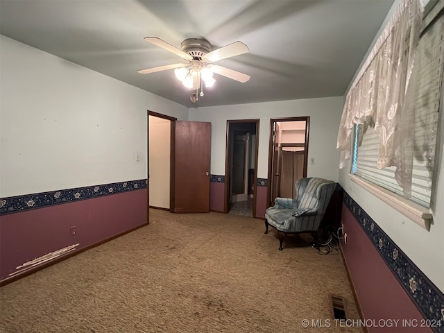 unfurnished room with ceiling fan and carpet floors