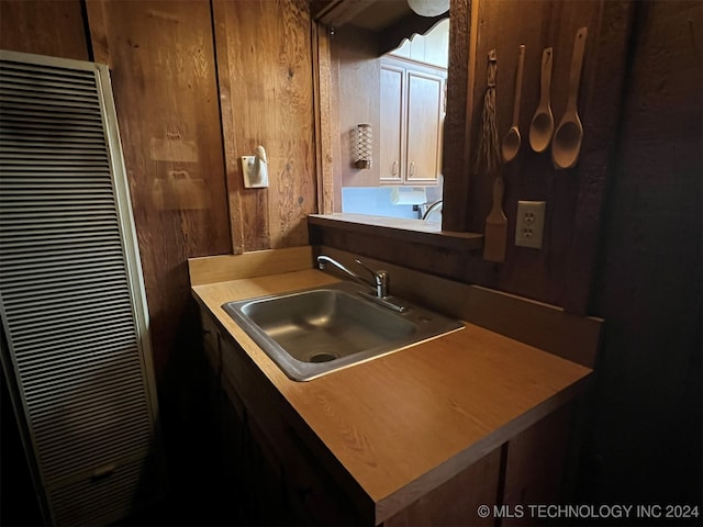 kitchen with wood walls and sink