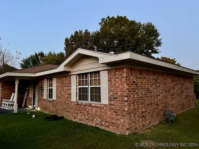 view of property exterior with a yard