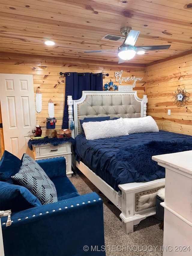 bedroom with carpet, wooden walls, and wood ceiling