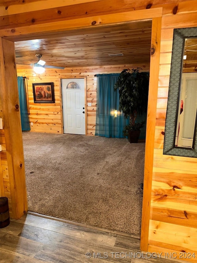 entryway with hardwood / wood-style flooring, wood ceiling, and wood walls