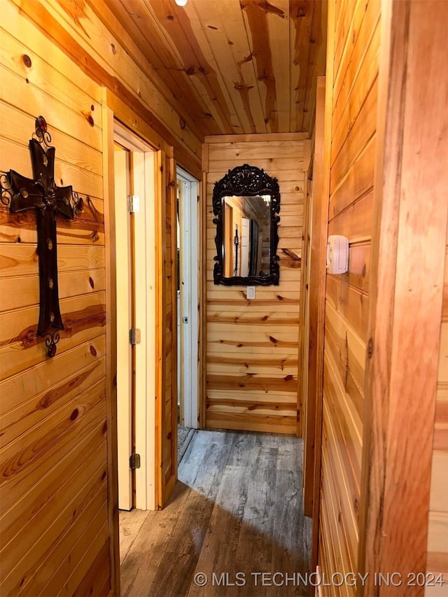 hallway with wood ceiling, wooden walls, and wood-type flooring