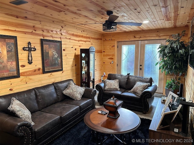 living room with wood walls, french doors, ceiling fan, and wood ceiling