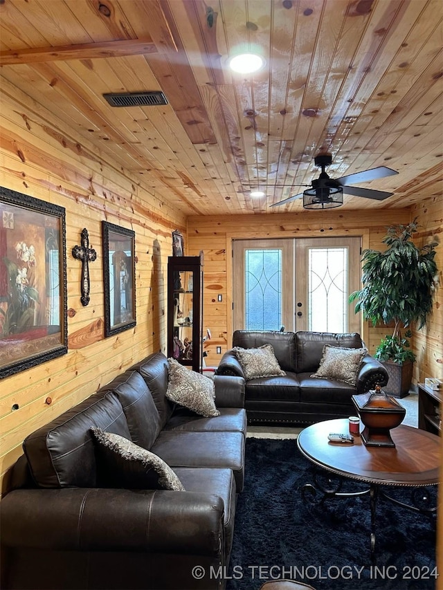 living room with wooden ceiling and wood walls