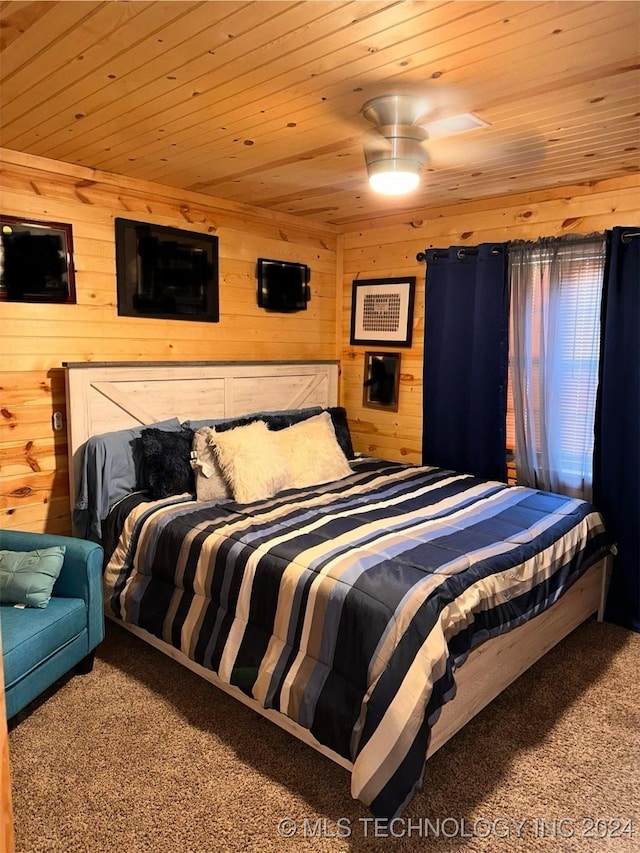 bedroom featuring carpet, wood walls, and wood ceiling