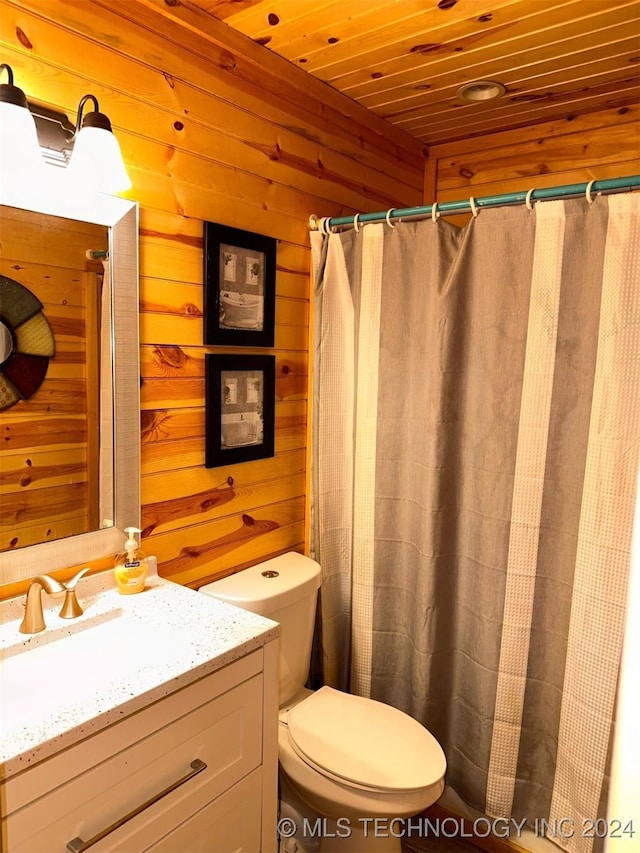 bathroom with vanity, toilet, wooden ceiling, and wooden walls