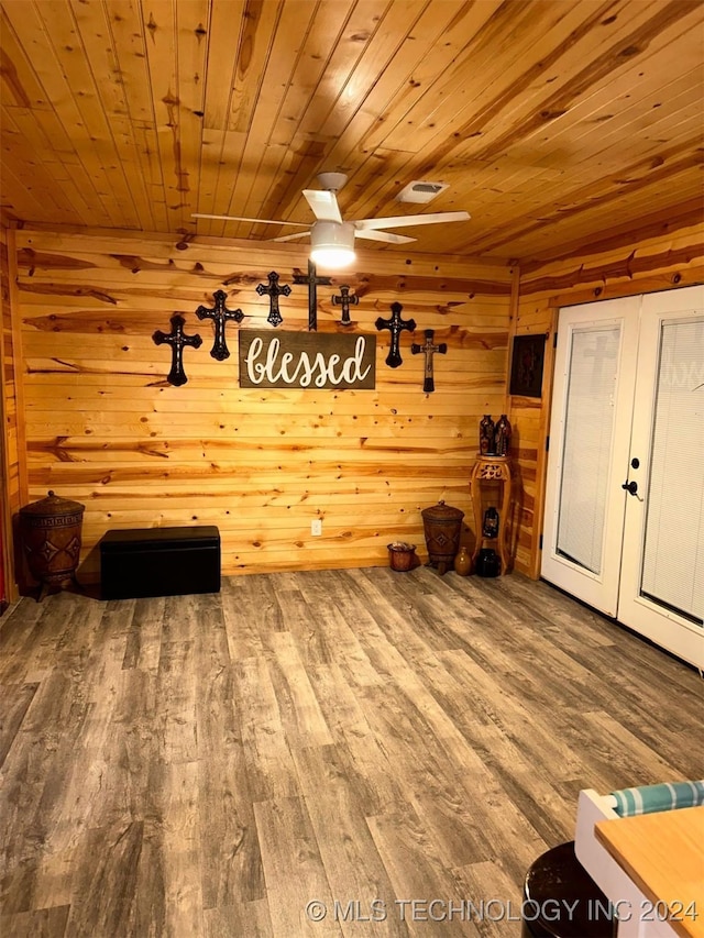 unfurnished room featuring hardwood / wood-style flooring, wood ceiling, and wooden walls