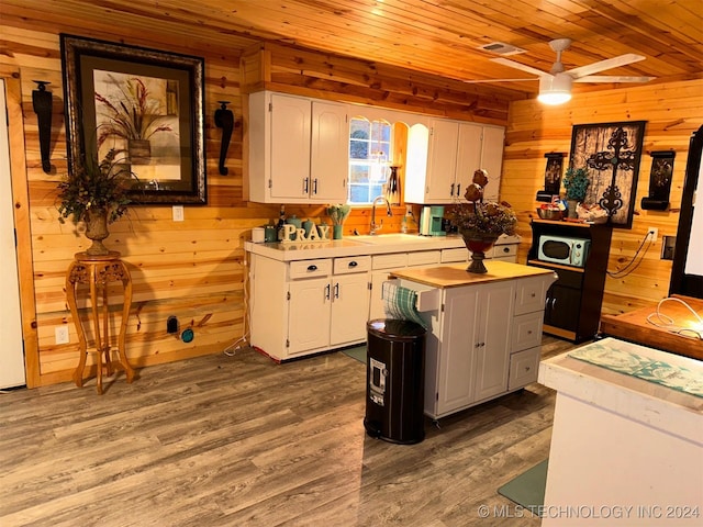 kitchen featuring white cabinets, ceiling fan, sink, and dark wood-type flooring