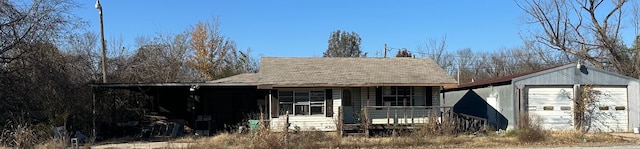 view of front of home with a garage, covered porch, and an outdoor structure