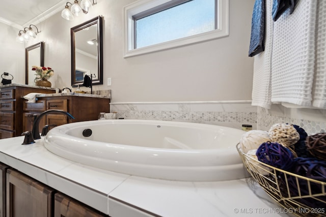 bathroom with ornamental molding, a tub, and vanity