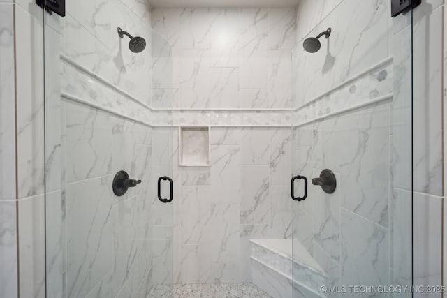 bathroom with a shower with door