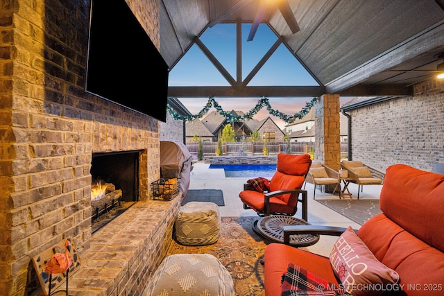 view of patio with pool water feature and an outdoor brick fireplace