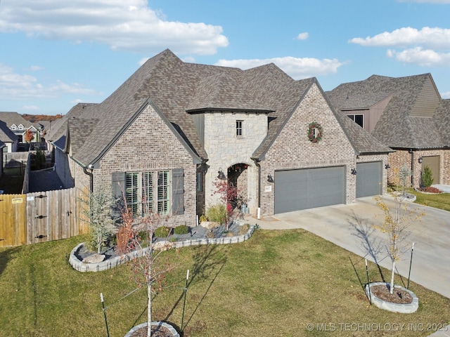 view of front of house with a front yard and a garage