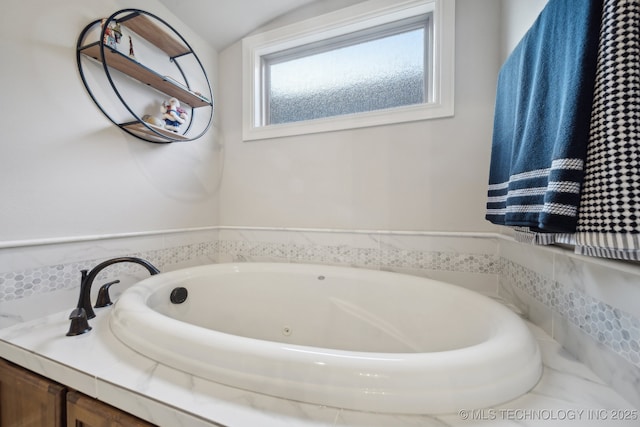 bathroom featuring lofted ceiling and a bathtub