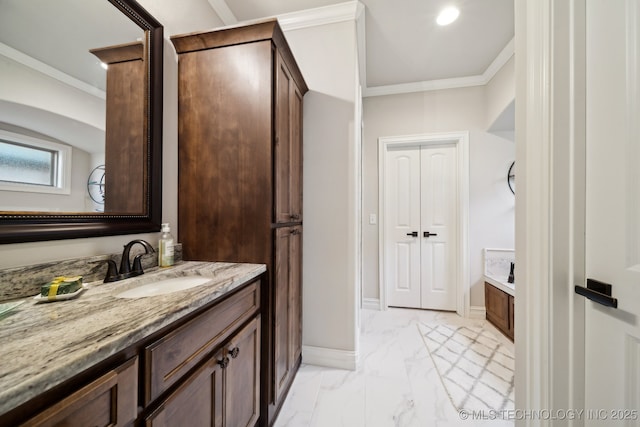 bathroom with vanity, ornamental molding, and a bathing tub