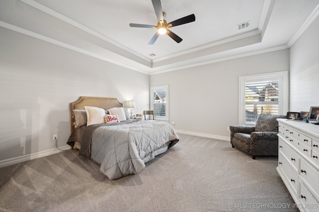 bedroom featuring light colored carpet, a raised ceiling, and ceiling fan