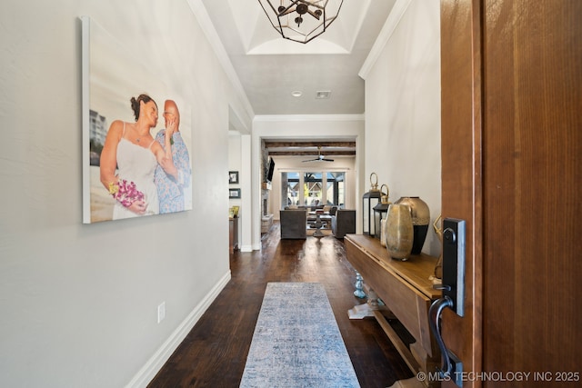 hallway with dark hardwood / wood-style flooring, a notable chandelier, and crown molding