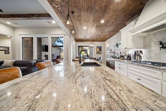 kitchen with wood ceiling, custom exhaust hood, decorative light fixtures, and white cabinets