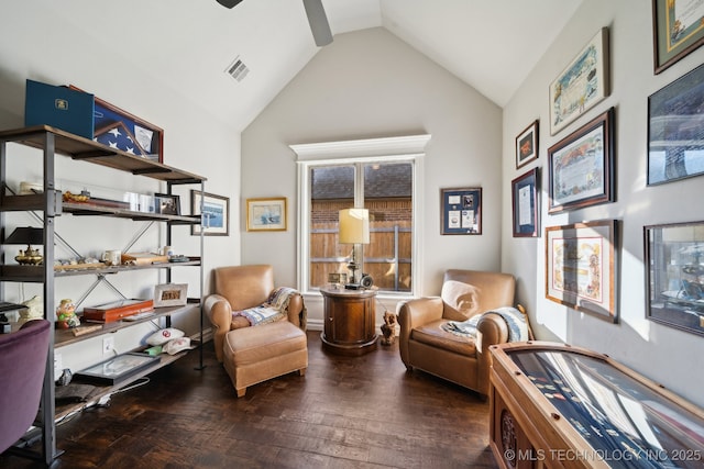 living area featuring dark wood-type flooring, ceiling fan, and vaulted ceiling