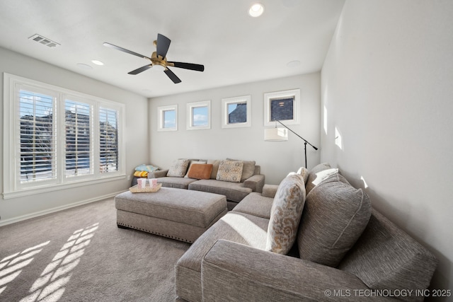 carpeted living room featuring ceiling fan