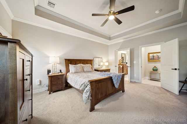 bedroom with a raised ceiling, ceiling fan, crown molding, and light colored carpet