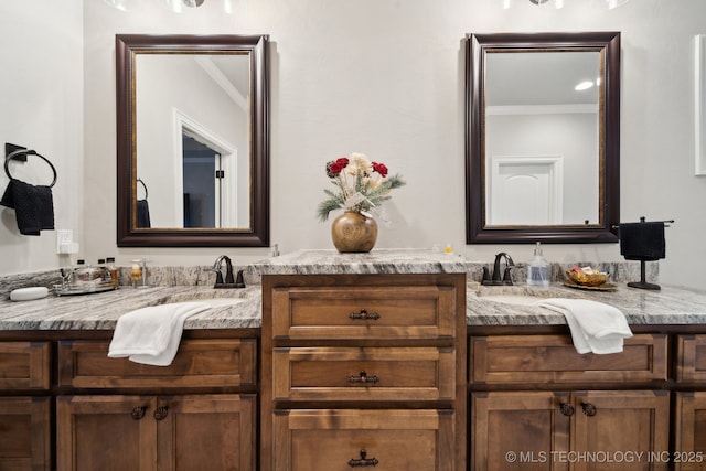 bathroom with ornamental molding and vanity