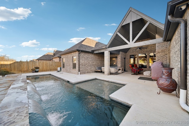 view of pool featuring a patio area, ceiling fan, and pool water feature