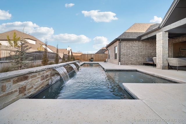 view of swimming pool with pool water feature and a patio area