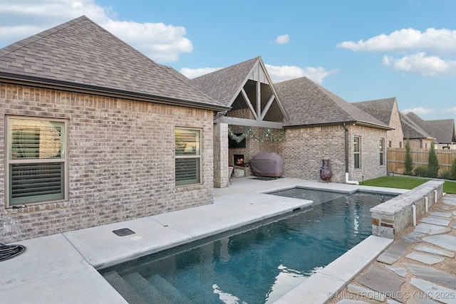 view of pool featuring a patio and a grill